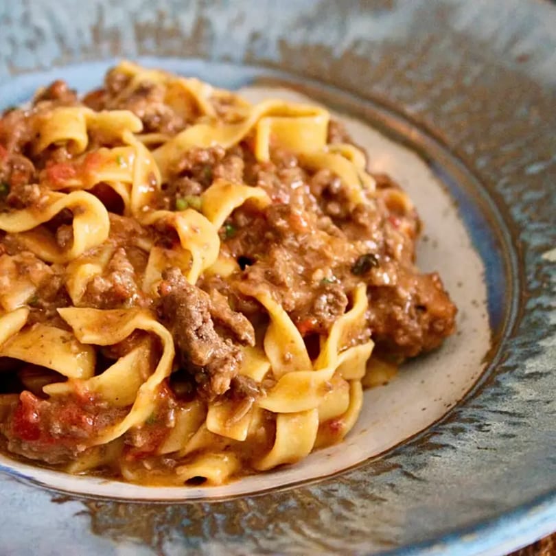 Close-up of Pinch Kitchen+Bar's American cuisine: tagliatelle pasta with a rich meat sauce.